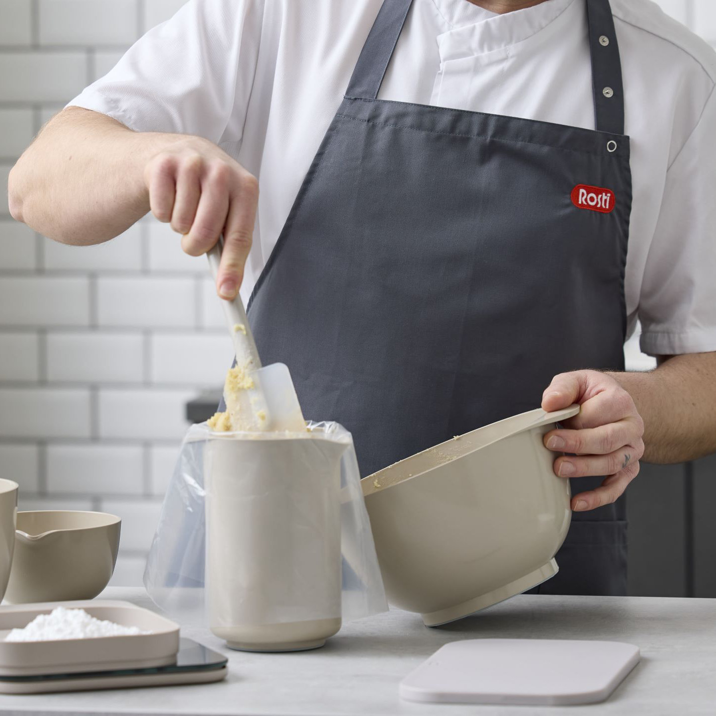 Person in the kitchen with various baking utensils