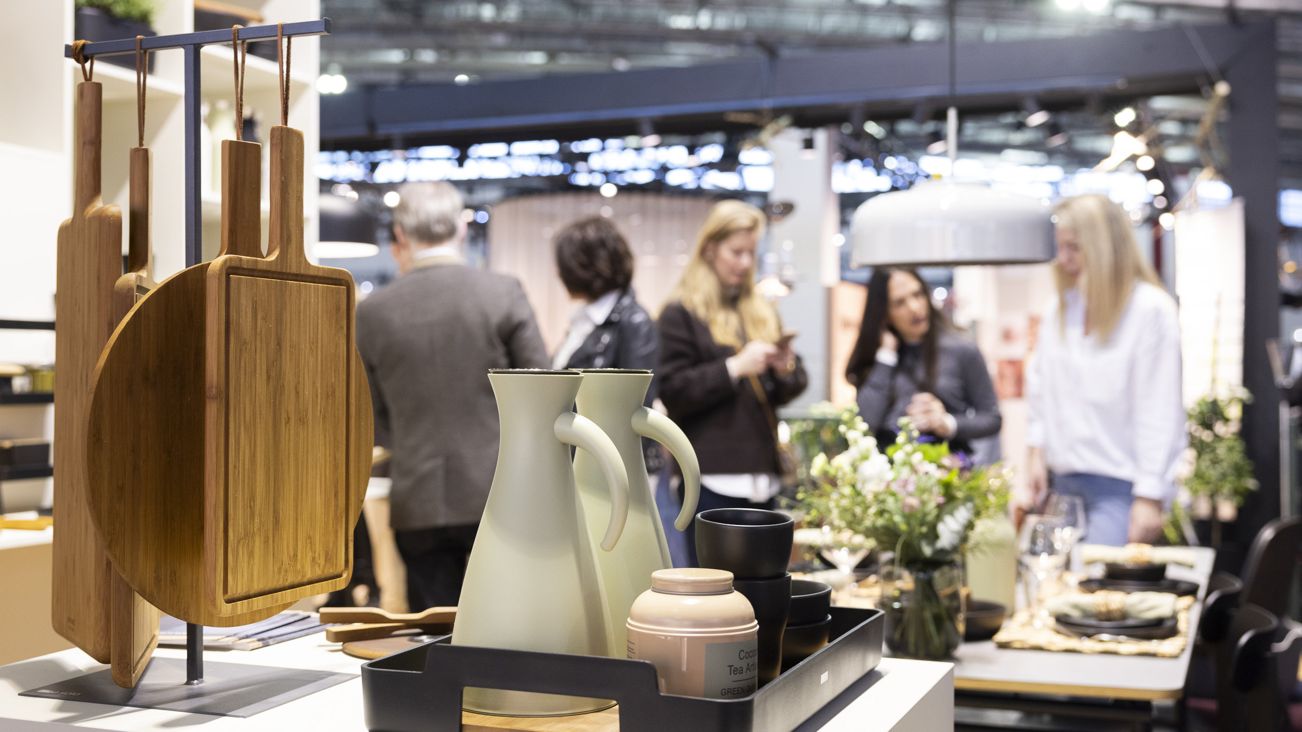 Trade fair visitors at an Ambiente stand with kitchen supplies