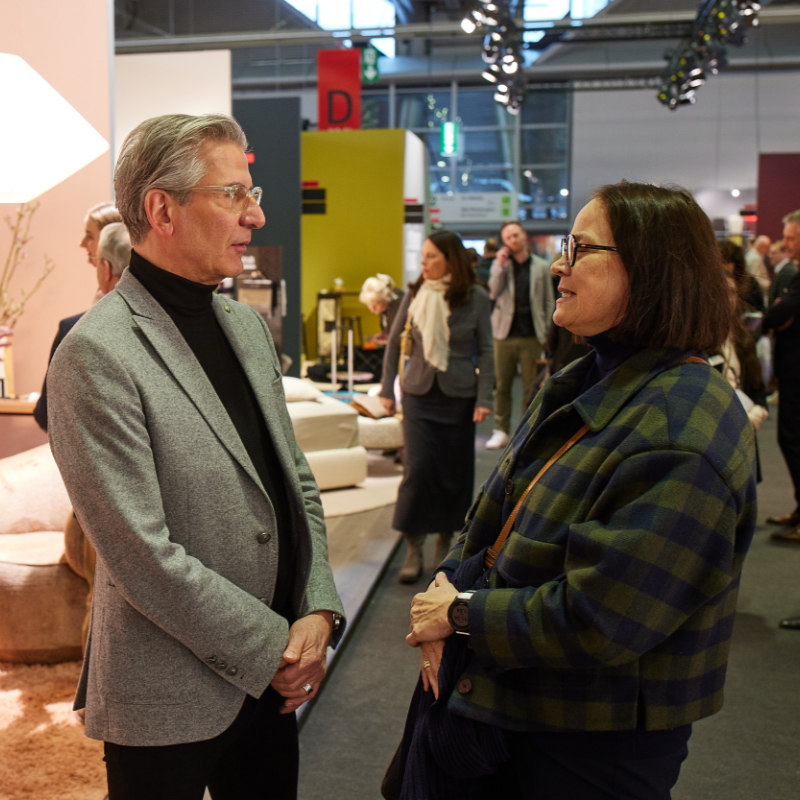 A woman and a man look at products at the Ambiente Trend Show.