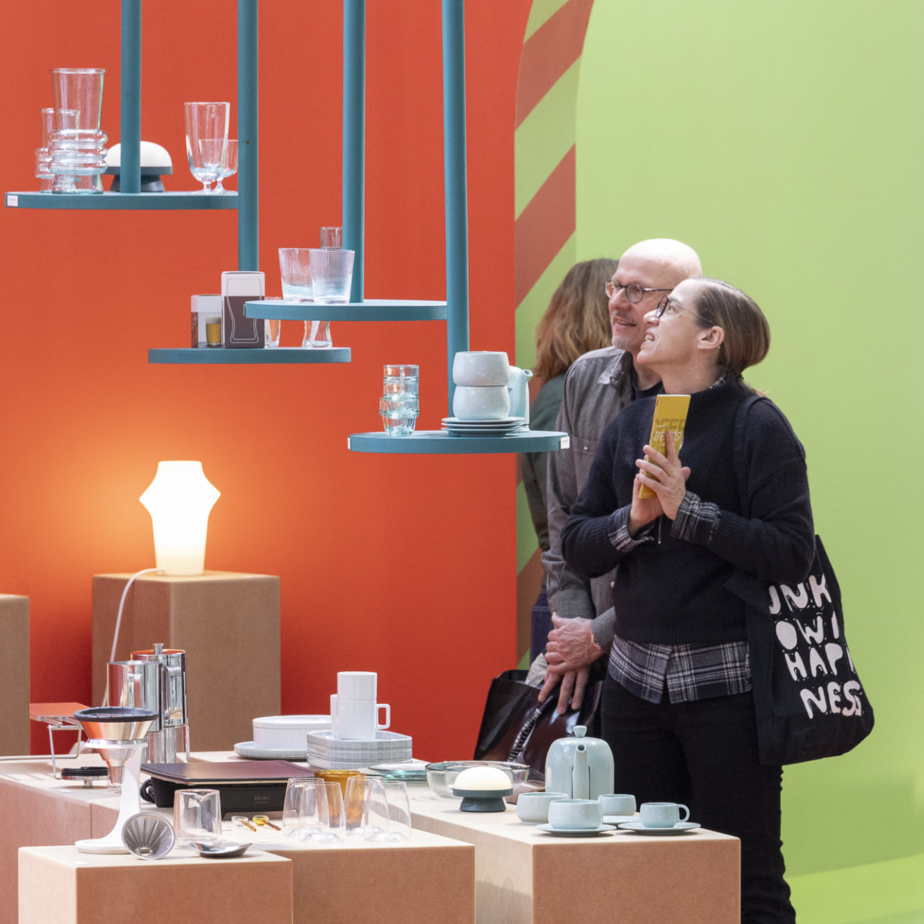 A woman and a man look at products at the Ambiente Trend Show.